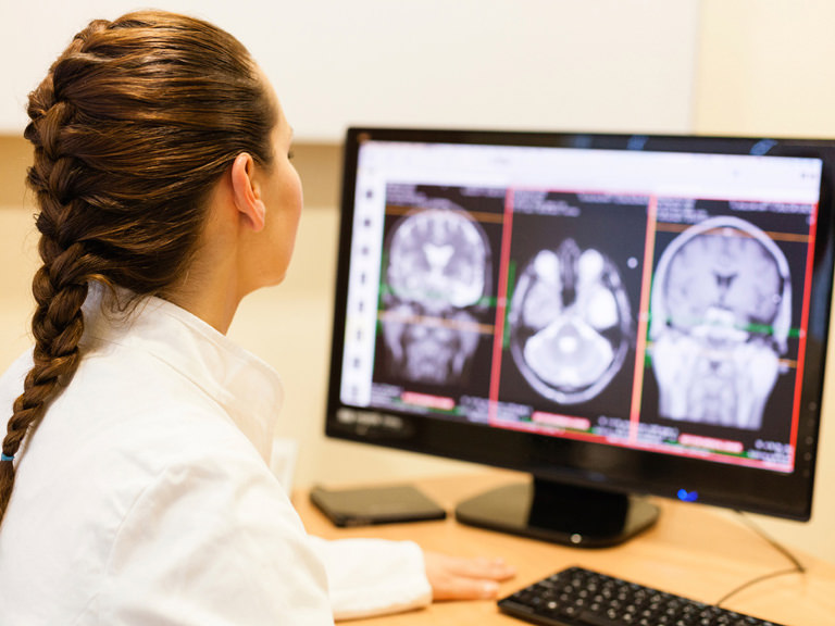 Technologist reviews brain scans.