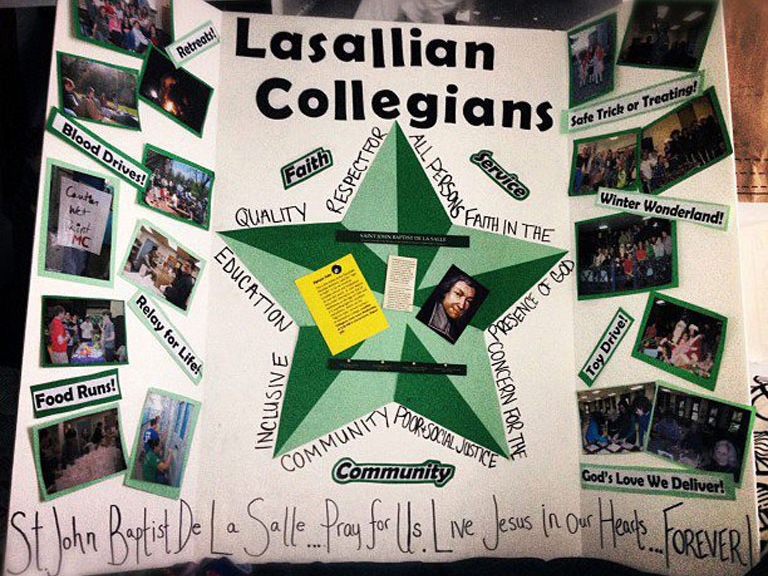 Lasallian Collegians present a poster advertising the organization.