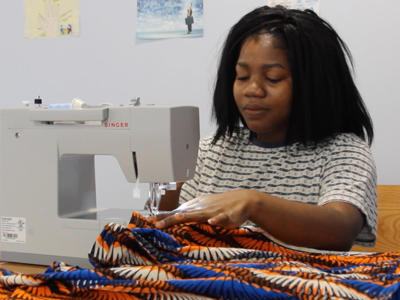 student designs clothes with sewing machine