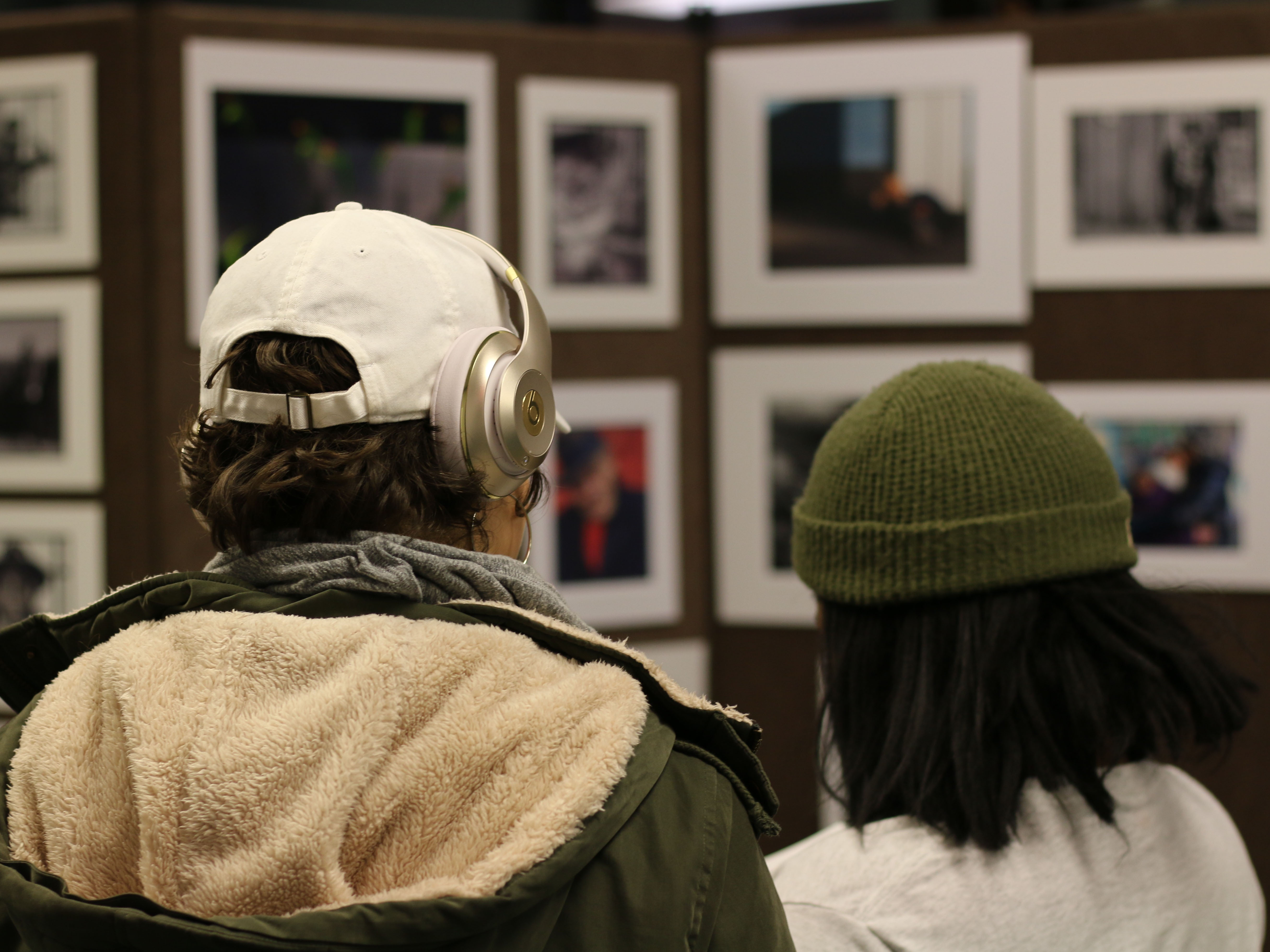 two students attend a campus art exhibit