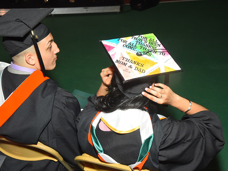 Student with a graduation cap thanking parents