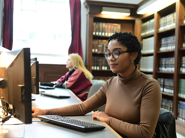 Woman at computer in library