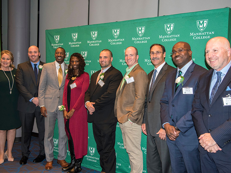 Athletics Hall of Fame class of 2018 in front of Manhattan College banner