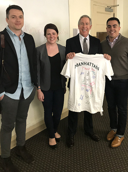 Manhattan College faculty giving Microsoft team a commemorative T-shirt