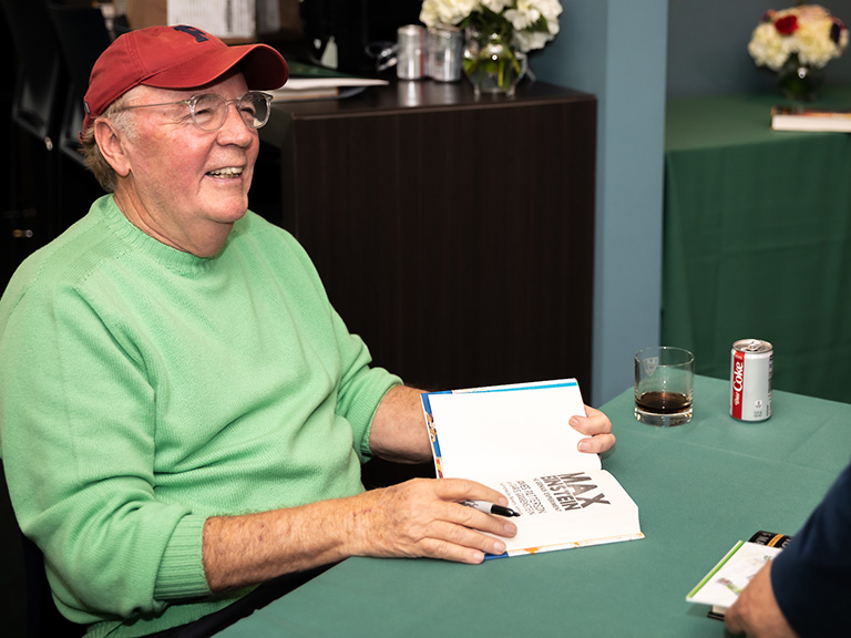 James Patterson signing books on campus