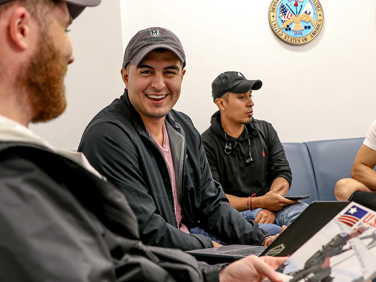 Student veterans laughing and talking in Veterans Success Center