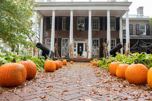 Picture of home with a walk way decorated with pumpkins